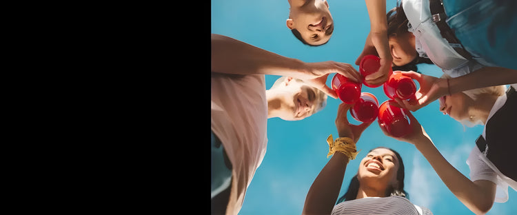 young people with cups, in a circle having a drink, on a nice day 